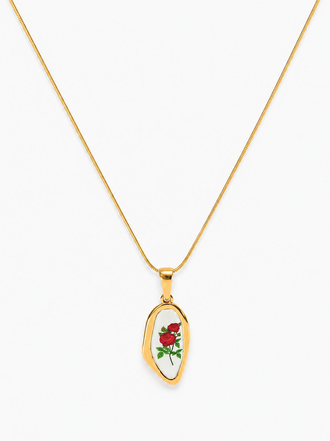 A gold chain necklace with an irregularly shaped pendant featuring a white background and a small red rose with green leaves, displayed on a clean white background.