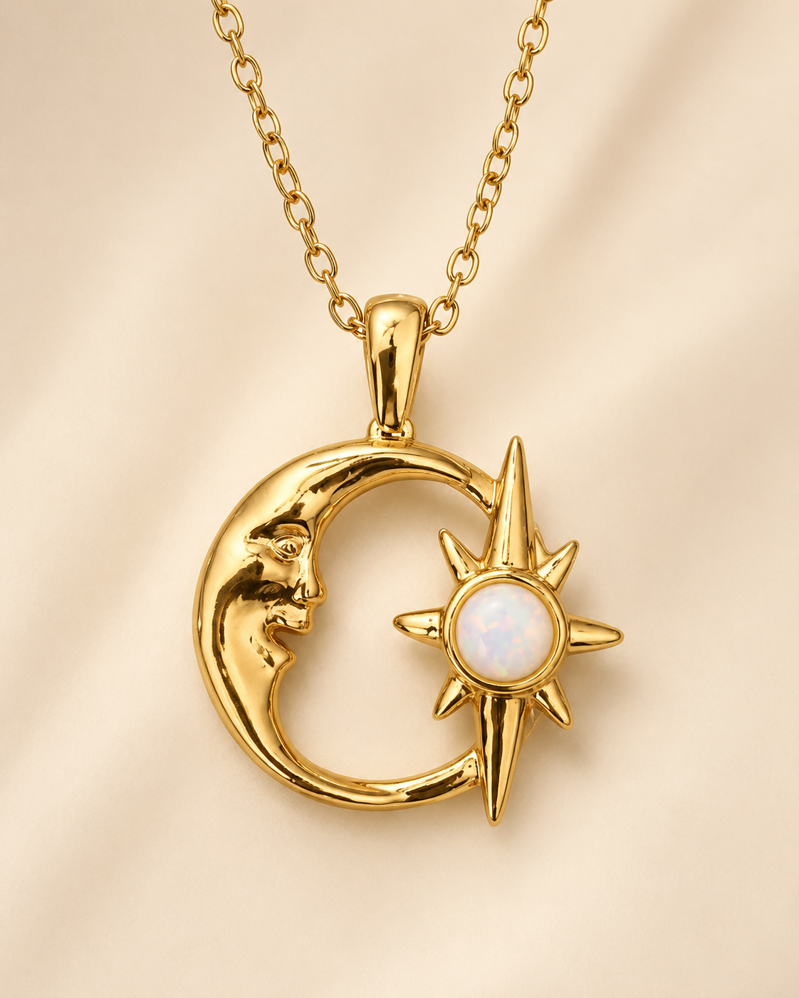Gold celestial moon necklace featuring a crescent moon, radiant star, and luminous white opal pendant on a soft beige background.