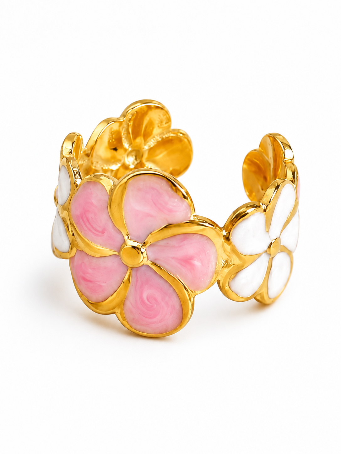 A gold-tone floral cuff bracelet featuring a large pink flower in the center and two smaller white flowers on either side, set against a plain white background.